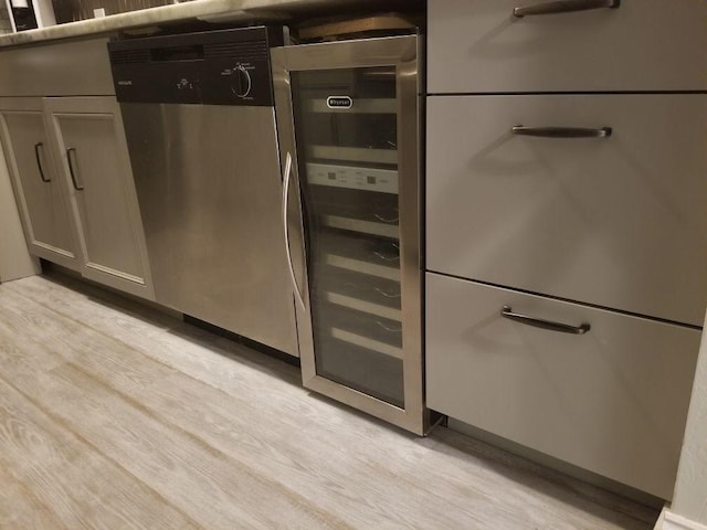 kitchen with wine cooler, dishwasher, and light hardwood / wood-style flooring