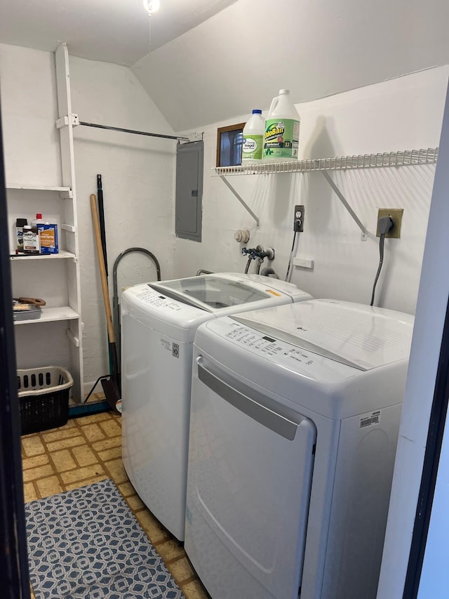 laundry room with laundry area, washing machine and dryer, and electric panel