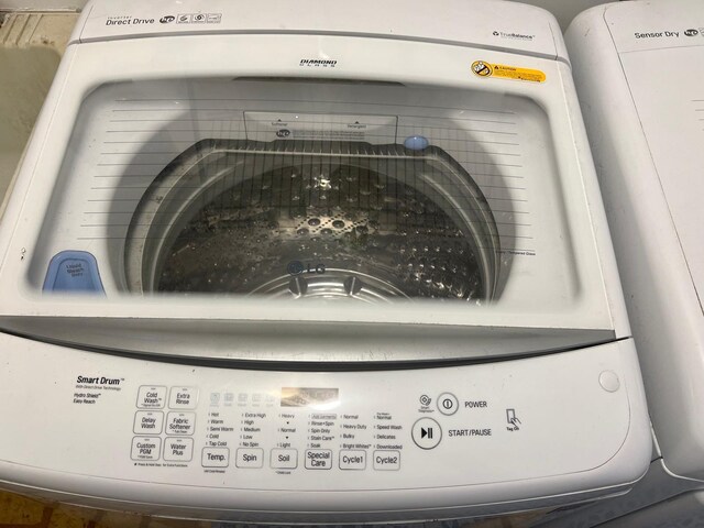 clothes washing area featuring electric panel and independent washer and dryer