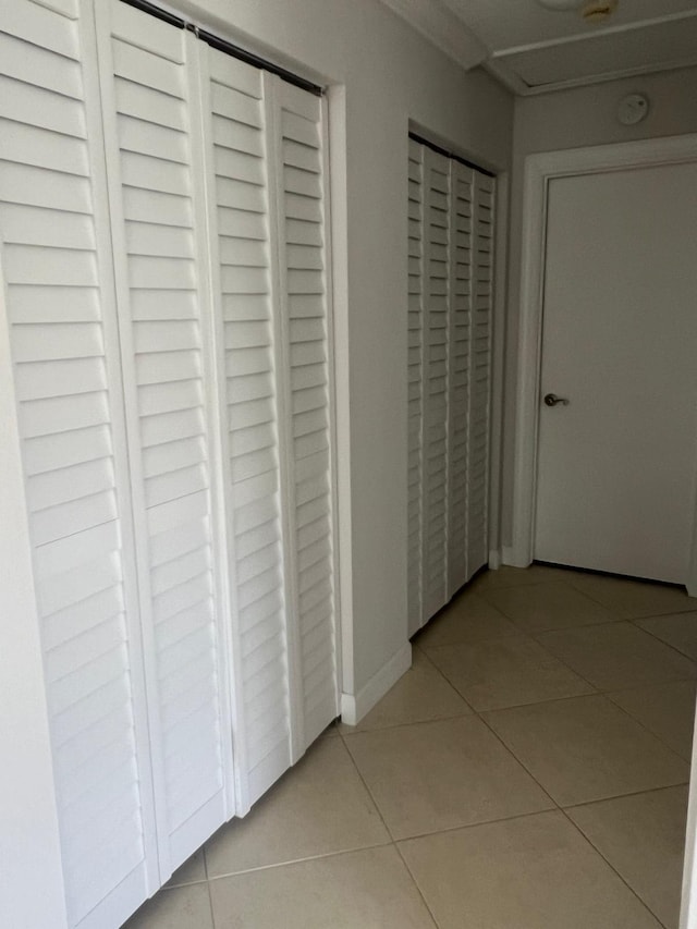 hall with light tile patterned floors