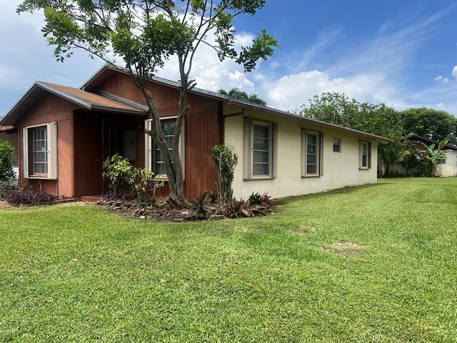 view of home's exterior featuring a lawn