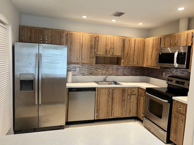 kitchen with decorative backsplash, stainless steel appliances, and sink