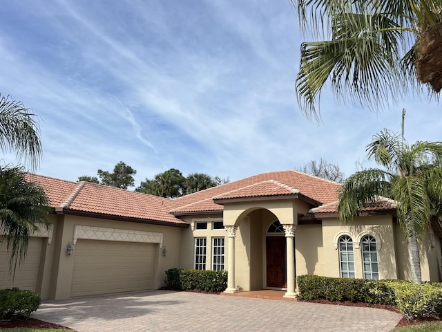 mediterranean / spanish-style home featuring a garage