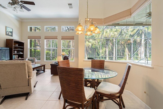 tiled dining area featuring crown molding and ceiling fan