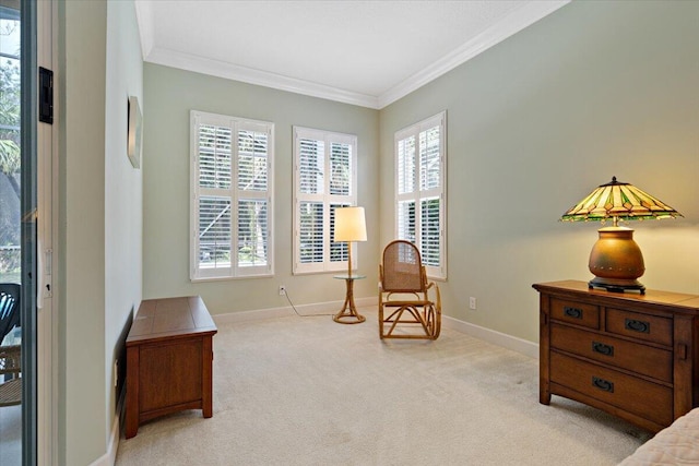 sitting room featuring ornamental molding and light carpet