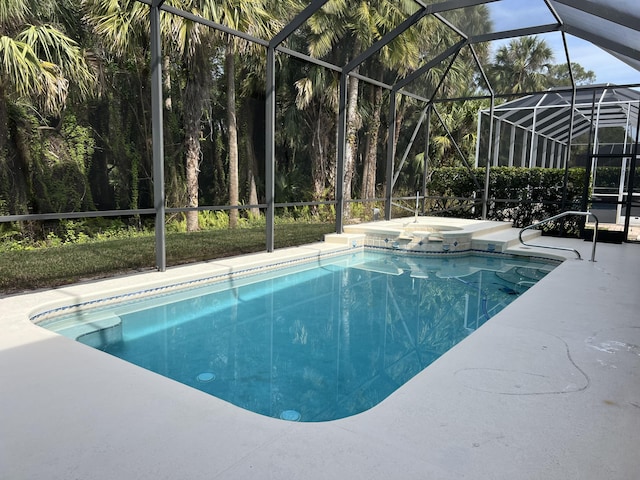 view of swimming pool with a lanai, a patio area, and an in ground hot tub