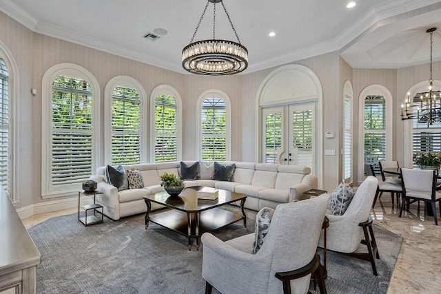 living area with a chandelier, crown molding, and wallpapered walls