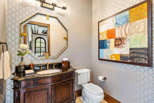 bathroom with toilet and vanity