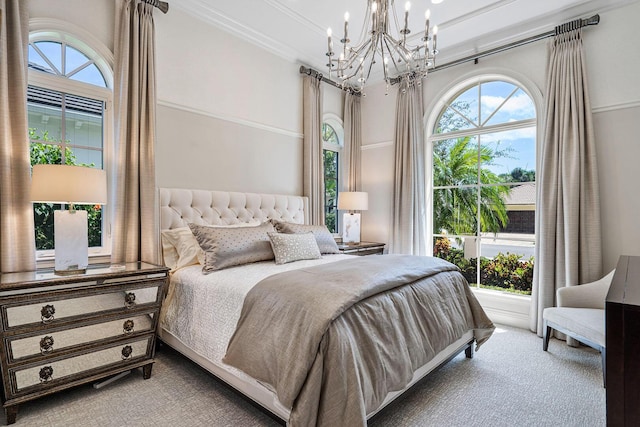 carpeted bedroom featuring ornamental molding and a notable chandelier
