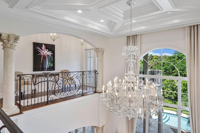 details featuring arched walkways, ornamental molding, recessed lighting, coffered ceiling, and a notable chandelier