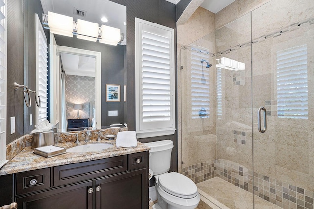 full bath featuring a shower stall, a healthy amount of sunlight, visible vents, and toilet