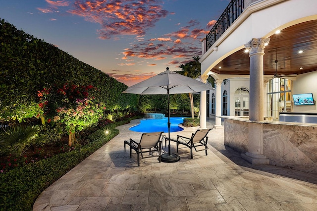 pool featuring ceiling fan, exterior kitchen, and a patio
