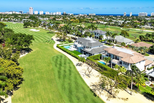 bird's eye view featuring view of golf course and a view of city