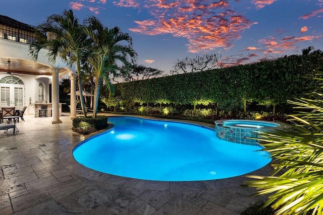 view of swimming pool with a patio area and a pool with connected hot tub