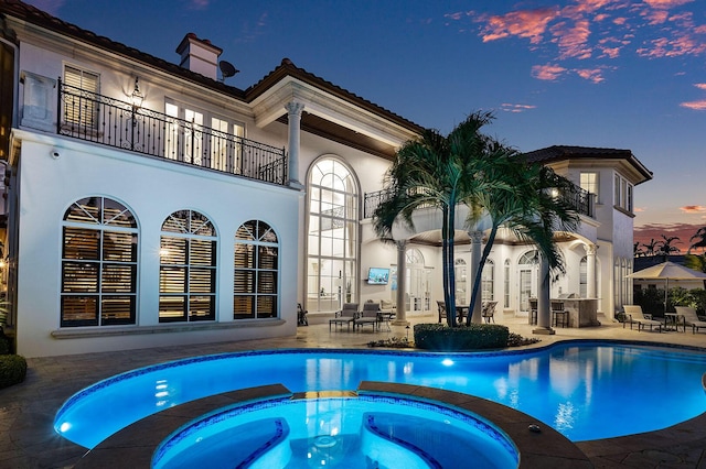 view of pool featuring a patio area and a pool with connected hot tub