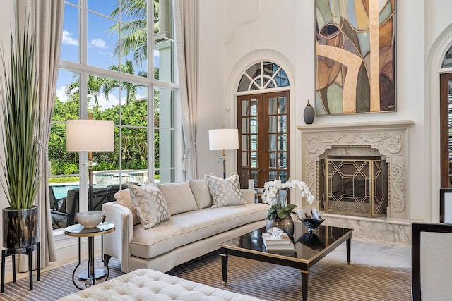 living area featuring a high ceiling and a fireplace
