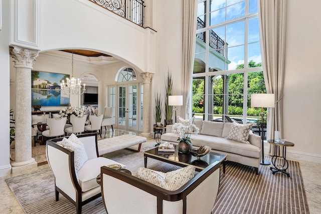 living room with arched walkways, ornate columns, and a high ceiling