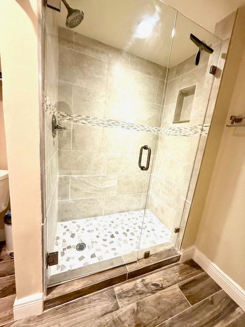 bathroom featuring a shower with shower door