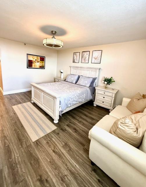 bedroom with dark hardwood / wood-style floors