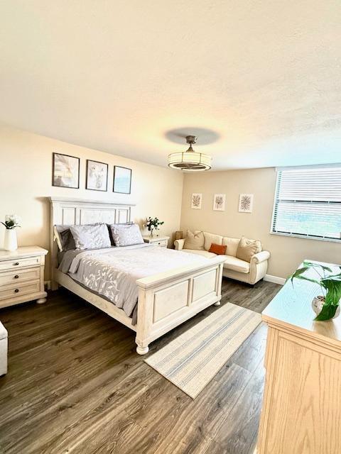 bedroom with dark wood-type flooring