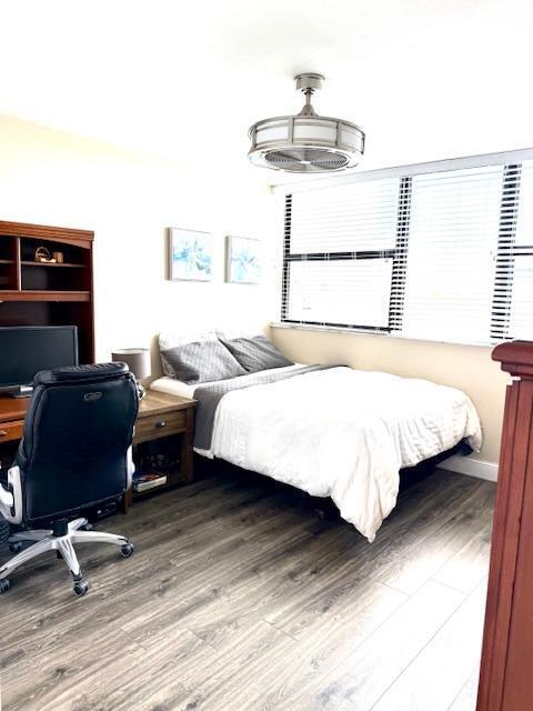 bedroom with hardwood / wood-style flooring