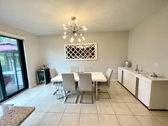 dining area featuring baseboards, a notable chandelier, and light tile patterned flooring