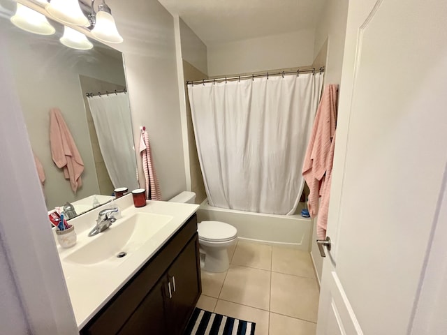 bathroom featuring toilet, tile patterned flooring, shower / tub combo with curtain, and vanity