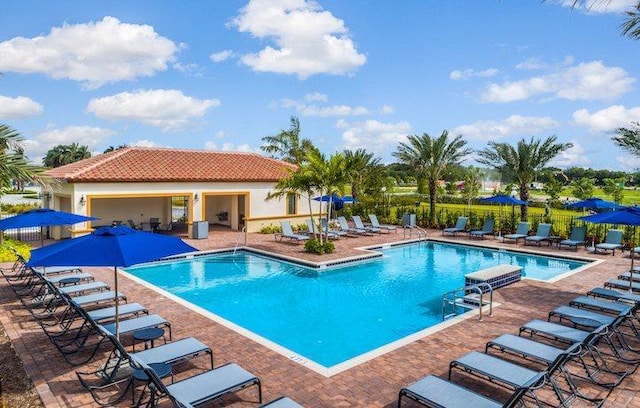 community pool featuring a patio area and fence