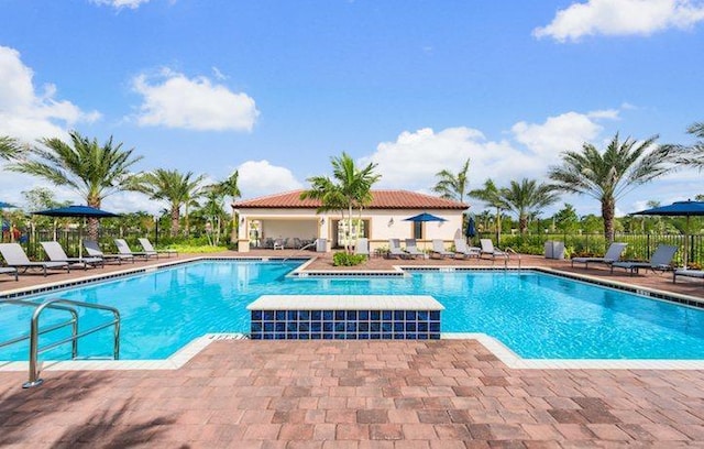 pool featuring a patio area and fence