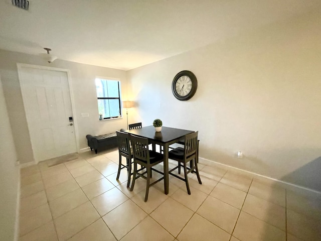 dining space with visible vents, baseboards, and light tile patterned floors