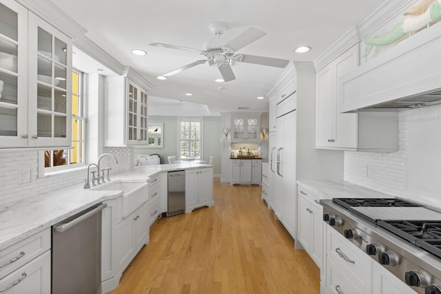 kitchen featuring white cabinets, light hardwood / wood-style floors, and stainless steel appliances