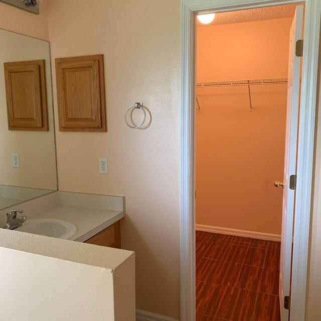 bathroom with tile floors and vanity