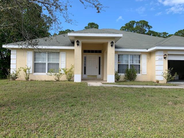 ranch-style home with a front lawn and a garage