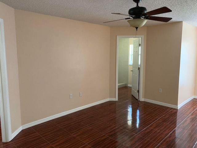 tiled spare room featuring a textured ceiling and ceiling fan