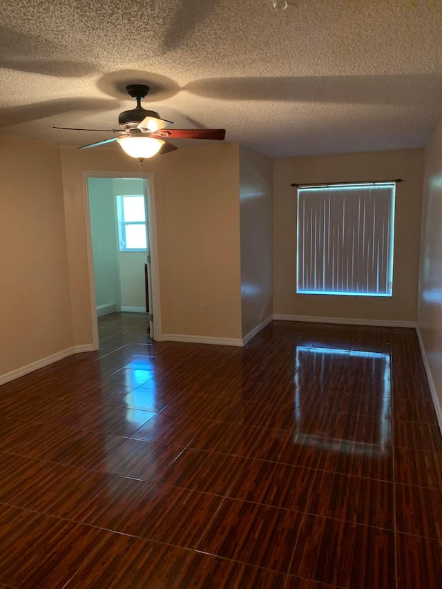 spare room featuring a textured ceiling and ceiling fan