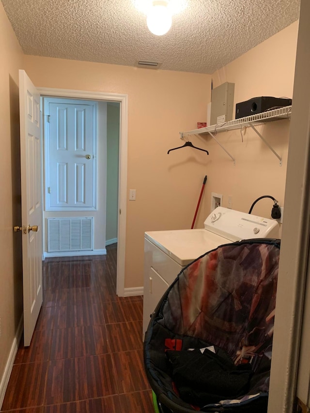 laundry room with washer / clothes dryer and a textured ceiling