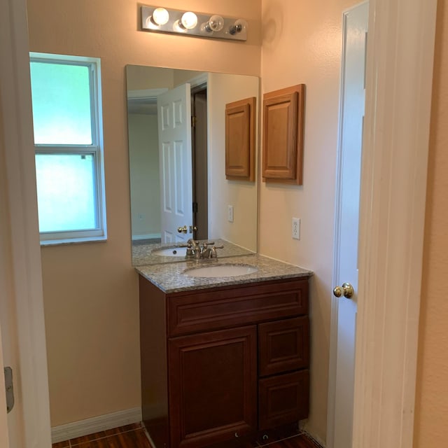 bathroom with vanity and hardwood / wood-style floors