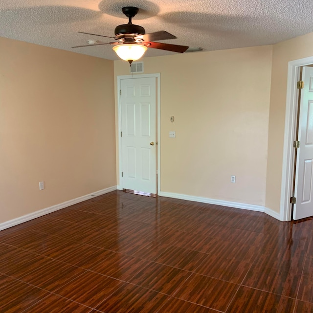 empty room with a textured ceiling and ceiling fan