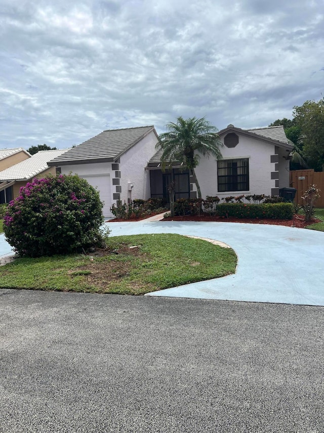 view of front of home with a garage and a front lawn