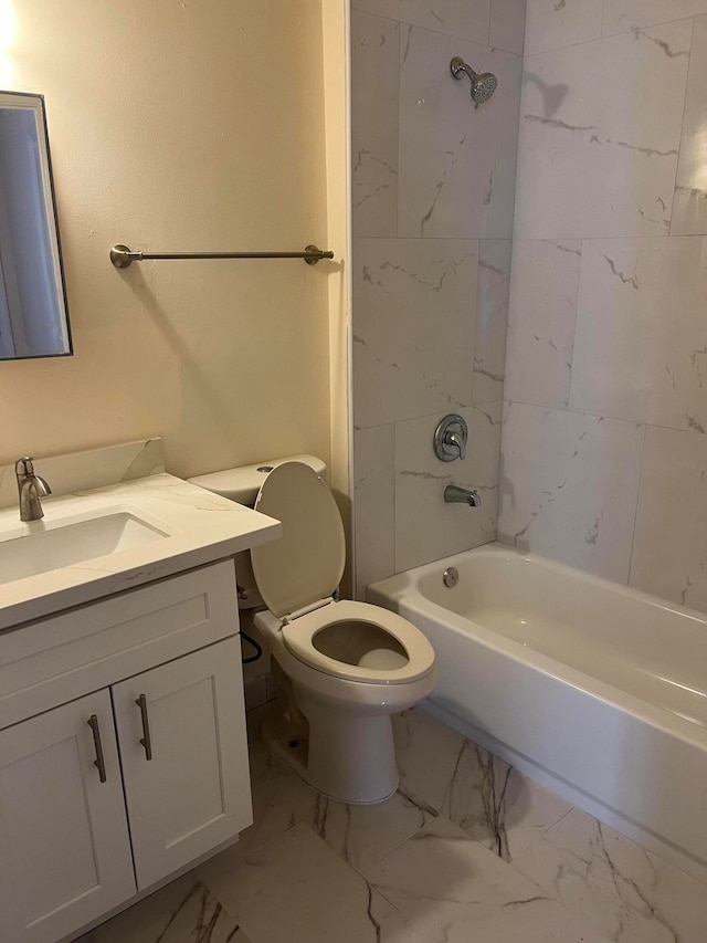 full bathroom featuring tile patterned floors, vanity, tiled shower / bath combo, and toilet