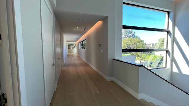 corridor with light hardwood / wood-style flooring