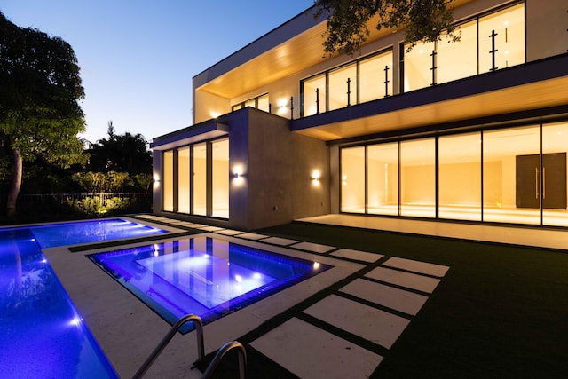 view of pool featuring a patio and an in ground hot tub