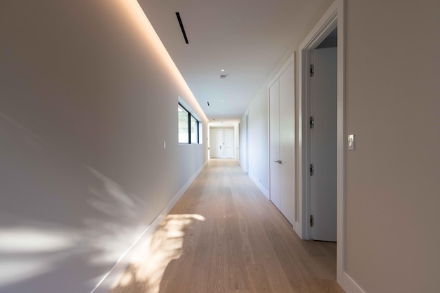 hall with light hardwood / wood-style flooring