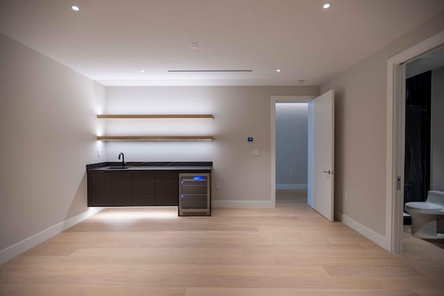 interior space featuring light hardwood / wood-style floors, sink, and beverage cooler