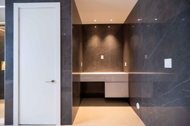 bathroom featuring tile walls, tile floors, and vanity