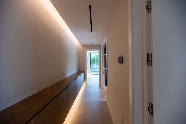 corridor with light hardwood / wood-style floors