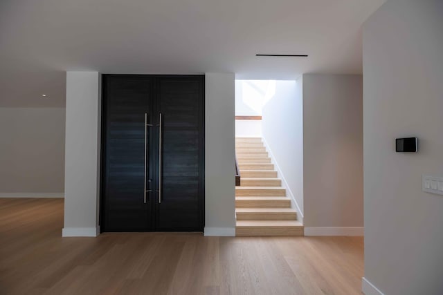 stairway with light wood-type flooring