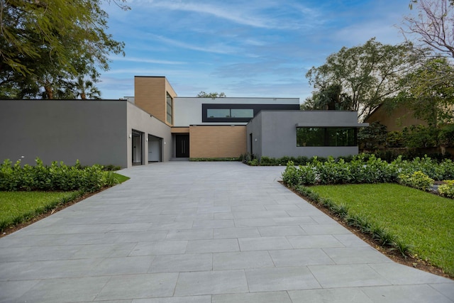 contemporary home with a front lawn