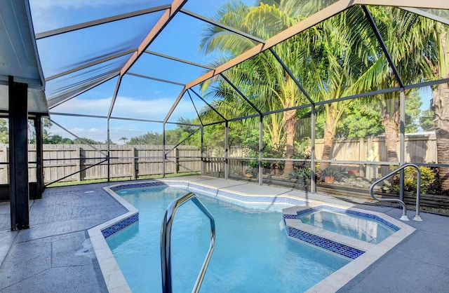 view of swimming pool featuring a patio area, a lanai, and an in ground hot tub