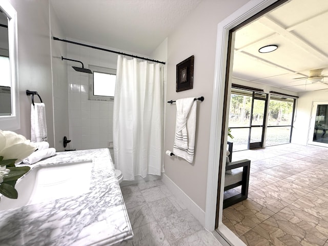 full bathroom featuring toilet, marble finish floor, baseboards, ceiling fan, and vanity